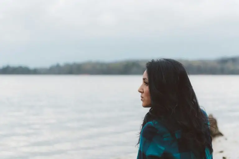 woman looking anxiously across a seascape.