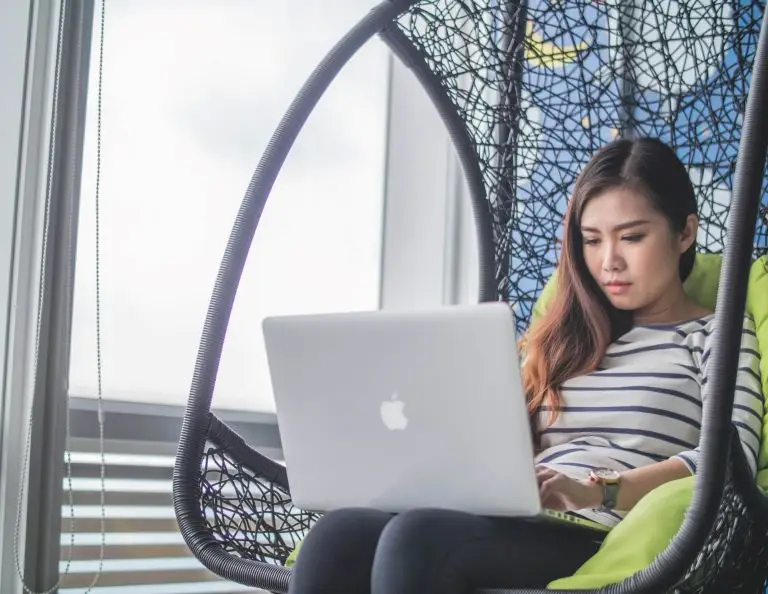 woman practicing mindfulness while working on a laptop computer