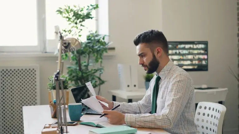 man in an office looking very stressed at work