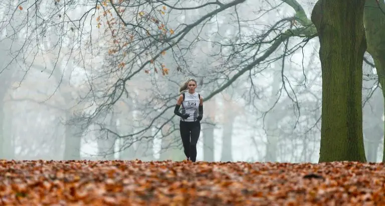 woman running in park to boost energy and immune systems