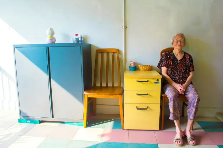 woman sitting on a chair happy to learn how to improve and sustain your breathwork practice