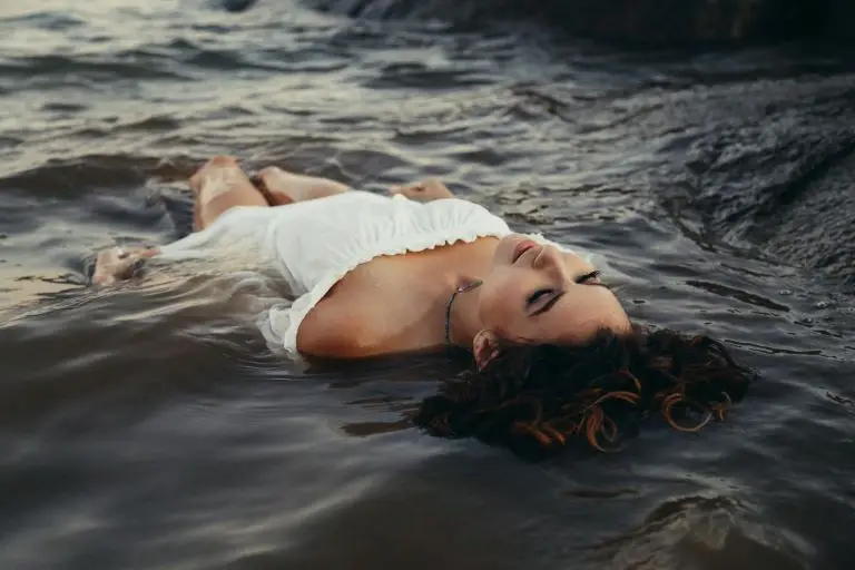 woman floating on ocean surface practicing mindfulness of emotions